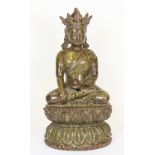 A Chinese olive green glazed pottery figure of a seated Buddha H28cms