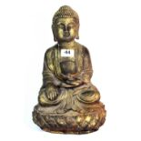 A gilt finished cast iron figure of a seated Buddha H 35cm