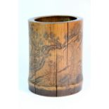 An early 20th century engraved bamboo brush pot decorated with ladies in a garden H 14cm