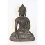 A Tibetan cast bronze figure of the seated Buddha with remnants of gilding, H 20cm