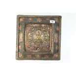 A superb 19th century Tibetan hammered and gilt brass and copper icon mounted over wood with ruby