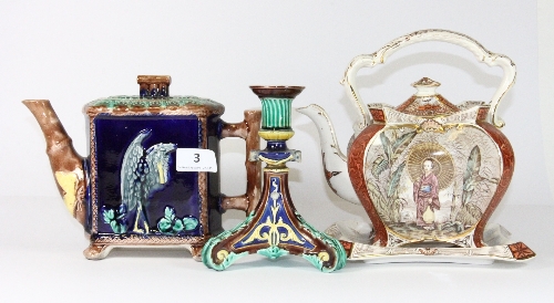 A 19th century majolica teapot, a Wedgwood majolica candlestick and a further oriental design teapot