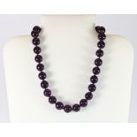 A single strand necklace of amethyst beads