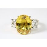 A superb 18ct yellow gold ring set with a large 8ct yellow sapphire and diamond shoulders (N.5).