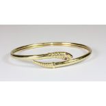 A 9ct gold snake bangle with ruby eyes