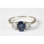 An 18ct white gold ring set with a sapphire and 2 diamonds (M)