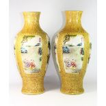 A pair of impressive Chinese relief decorated and hand enamelled porcelain vases with panels