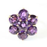 A very pretty 9ct yellow gold ring set with a cluster of large amethysts. Size R.