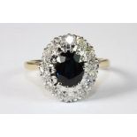 An 18ct yellow gold sapphire and diamond cluster ring. Size Q
