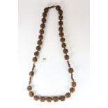 An interesting early necklace of carved wooden beads