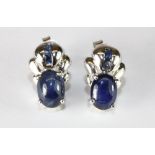 A pair of 9ct white gold earrings set with cabochon sapphires.