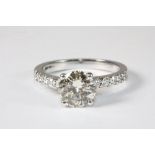 An 18ct white gold ring set with a solitaire diamond approx. 1.75ct with diamond set shoulders. Size