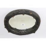 A natural form oval carved wooden mirror, W 35cm x 29cm