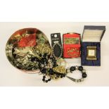 A tin of mixed costume jewellery