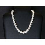 A lovely single strand necklace of large cultured pearls