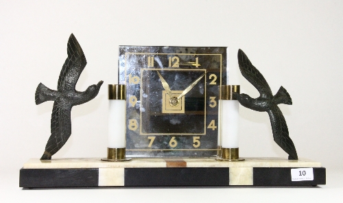 An Art Deco marble and bronze electric clock with illuminated pillars