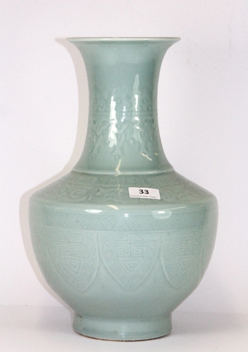 A fine quality Chinese celadon glazed and relief decorated porcelain vase with 4 character mark to