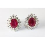 A pair of 18ct white gold earrings set with rubies (approx. 3.92ct) surrounded by diamonds (