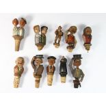 A collection of mostly articulated Black Forest wooden wine bottle stoppers