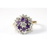 An 18ct gold diamond and amethyst cluster ring (J.5)