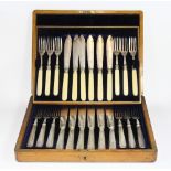 A case containing 2 sets of hallmarked silver cutlery