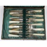 A cased hallmarked silver and mother of pearl fish set