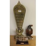 A brass fan fire screen, wooden eagle and a glass ship in a bottle
