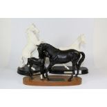 Two Royal Doulton "Spirit of the wind" figures and a Beswick "Black beauty and foal".