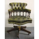 A button backed leather upholstered swivel captains chair