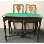 A 19th century ebonised card table and a pair of French cane seated chairs.