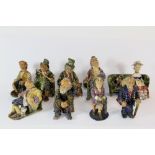 A set of nine handmade glazed pottery figurines of Dickens characters.