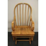 A contemporary elm rocking chair.