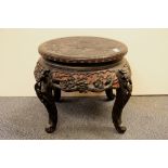 A 1920s oriental carved wooden table with black painted finish, W. 55cm, H. 37cm.