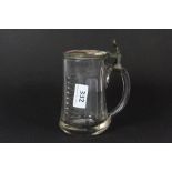 A 19th century cut glass hand painted porcelain and pewter beer jug, H. 16cm.