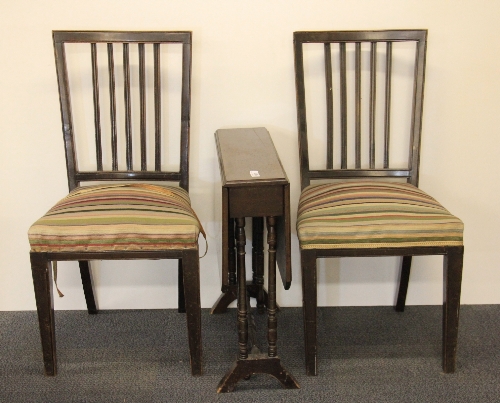 An Edwardian mahogany Pembroke table and a pair of dining chairs.