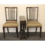 An Edwardian mahogany Pembroke table and a pair of dining chairs.