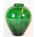 A 19th/early 20th century Chinese green glazed and incised pottery vase, H. 17cm.