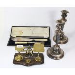 A pair of silver plated candle sticks, a Post Office scale and fish serving set.