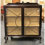 A 1930s ball and claw foot mahogany display cabinet, W. 118cm x H. 137cm.