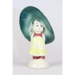 A 1930s figure of a little girl wearing a large hat (probably Hummel), H. 10cm.