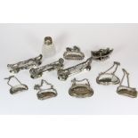 Three French silver plated knife rests, a figure, 6 decanter labels and a silver mounted perfume