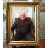 A gilt composite picture frame with scro