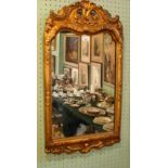 A gilt composite wall mirror, the frame