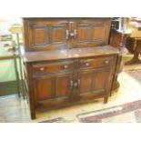 A reproduction Ercol oak court cupboard.