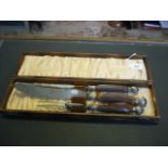 A cased Edwardian three piece carving se