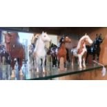 Five Beswick horses, including a black g