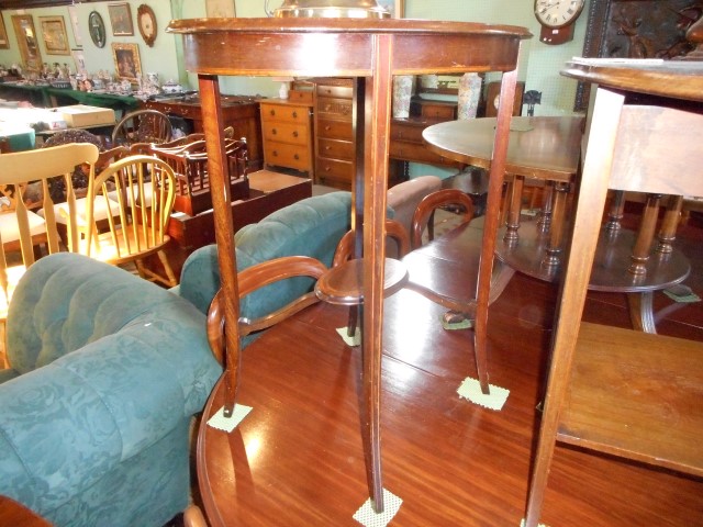 An Edwardian mahogany and strung occasional table, the oval top on slightly splayed square tapering