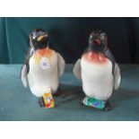 A pair of Beswick fireside penguins by Albert Hallam, model number 2357, one with shaded red