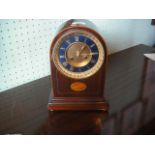 An Edwardian mantle clock, the twin train striking movement with gilt and enamelled dial in a