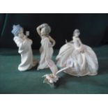 A Lladro figure of a seated ballerina and three other Lladro figures.